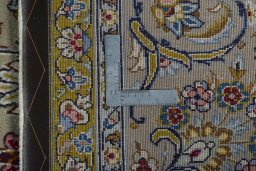 Backside of handmade 2000s Kashan rug showing knot structure and weave density