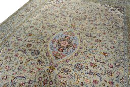 Backside of handmade 2000s Kashan rug showing knot structure and weave density