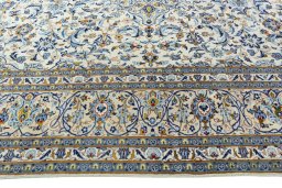 Corner detail of 2000s Kashan rug showing border pattern and Wool pile