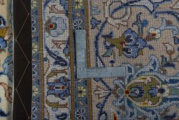 Backside of handmade 2000s Kashan rug showing knot structure and weave density