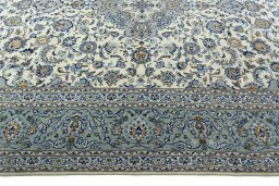 Corner detail of 2000s Kashan rug showing border pattern and Wool pile