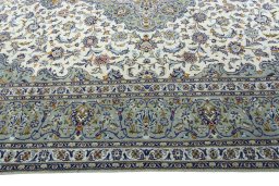 Corner detail of 2000s Kashan rug showing border pattern and Wool pile