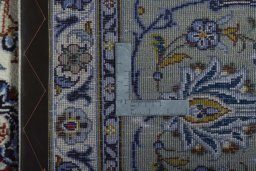 Backside of handmade 2000s Kashan rug showing knot structure and weave density