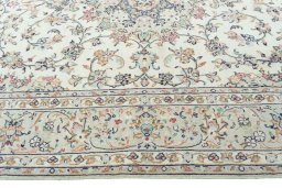 Corner detail of 2000s Kashan rug showing border pattern and Wool pile