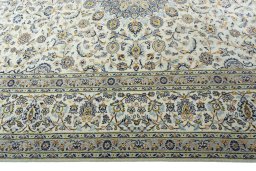 Corner detail of 2000s Kashan rug showing border pattern and Wool pile