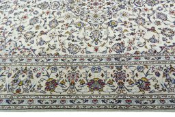 Corner detail of 2000s Kashan rug showing border pattern and Wool pile