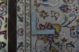Backside of handmade 2000s Kashan rug showing knot structure and weave density