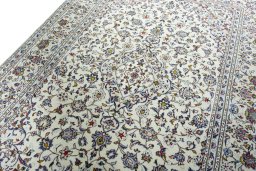 Backside of handmade 2000s Kashan rug showing knot structure and weave density