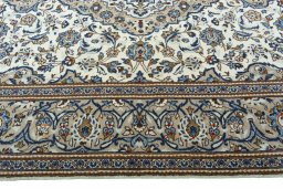 Corner detail of 2000s Kashan rug showing border pattern and Wool pile