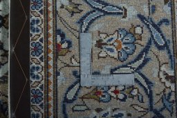 Backside of handmade 2000s Kashan rug showing knot structure and weave density