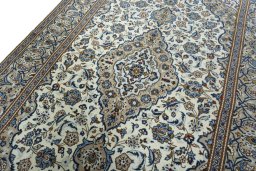 Backside of handmade 2000s Kashan rug showing knot structure and weave density