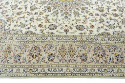 Corner detail of 2000s Kashan rug showing border pattern and Wool pile