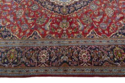 Corner detail of 2000s Kashan rug showing border pattern and Wool pile