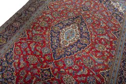 Backside of handmade 2000s Kashan rug showing knot structure and weave density