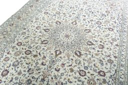 Backside of handmade 2000s Kashan rug showing knot structure and weave density