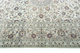 Corner detail of 2000s Kashan rug showing border pattern and Wool pile