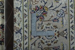 Backside of handmade 2000s Kashan rug showing knot structure and weave density