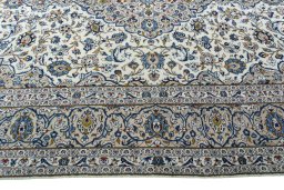 Corner detail of 2000s Kashan rug showing border pattern and Wool pile
