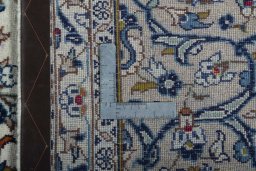Backside of handmade 2000s Kashan rug showing knot structure and weave density