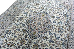 Backside of handmade 2000s Kashan rug showing knot structure and weave density