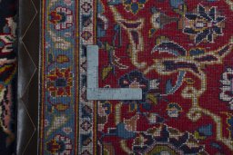 Backside of handmade 2000s Kashan rug showing knot structure and weave density