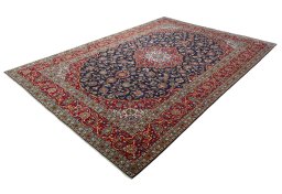 Corner detail of 2000s Kashan rug showing border pattern and Wool pile