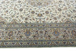 Corner detail of 2000s Kashan rug showing border pattern and Wool pile
