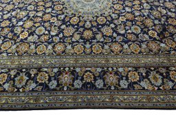 Corner detail of 2000s Kashan rug showing border pattern and Wool pile
