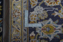 Backside of handmade 2000s Kashan rug showing knot structure and weave density