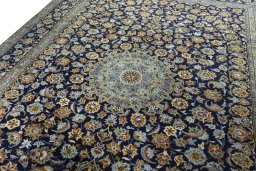 Backside of handmade 2000s Kashan rug showing knot structure and weave density
