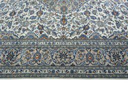 Corner detail of 2000s Kashan rug showing border pattern and Wool pile