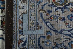 Backside of handmade 2000s Kashan rug showing knot structure and weave density