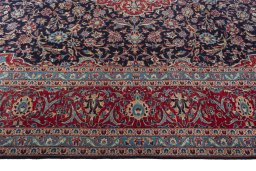 Corner detail of 2000s Kashan rug showing border pattern and Wool pile