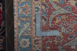 Backside of handmade 2000s Kashan rug showing knot structure and weave density