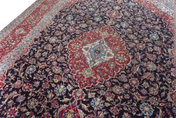 Backside of handmade 2000s Kashan rug showing knot structure and weave density