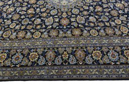 Corner detail of 2000s Kashan rug showing border pattern and Wool pile