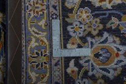 Backside of handmade 2000s Kashan rug showing knot structure and weave density