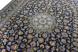 Backside of handmade 2000s Kashan rug showing knot structure and weave density