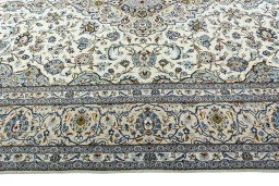 Corner detail of 2000s Kashan rug showing border pattern and Wool pile