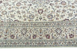 Corner detail of 2000s Kashan rug showing border pattern and Wool pile