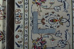 Backside of handmade 2000s Kashan rug showing knot structure and weave density