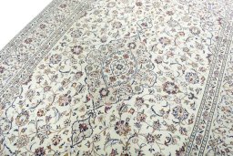 Backside of handmade 2000s Kashan rug showing knot structure and weave density