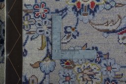 Backside of handmade New Kashan rug showing knot structure and weave density