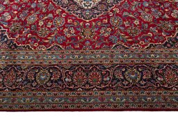 Corner detail of 2000s Kashan rug showing border pattern and Wool pile