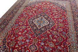 Backside of handmade 2000s Kashan rug showing knot structure and weave density