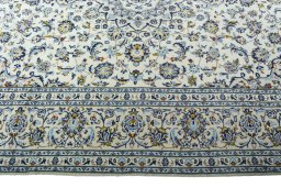 Corner detail of 2000s Kashan rug showing border pattern and Wool pile