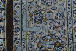Backside of handmade 2000s Kashan rug showing knot structure and weave density
