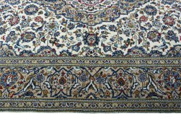 Corner detail of 2000s Kashan rug showing border pattern and Wool pile