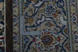 Backside of handmade 2000s Kashan rug showing knot structure and weave density