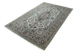 Corner detail of 2000s Kashan rug showing border pattern and Wool pile